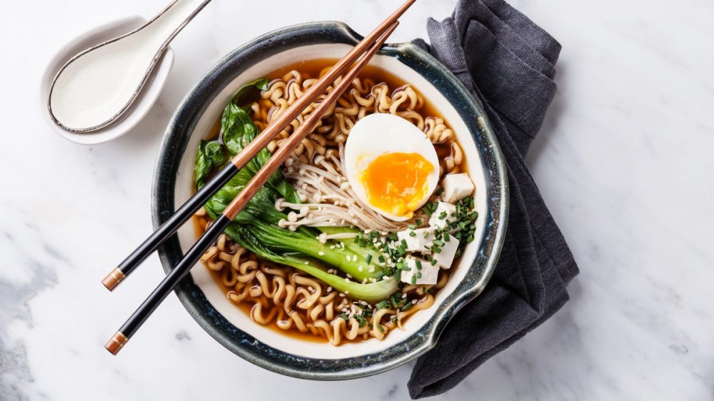 Chopsticks sit on top of a bowl of ramen.