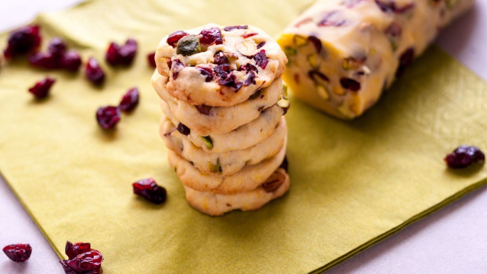 Cranberry pistachio cookies on a green napkin.