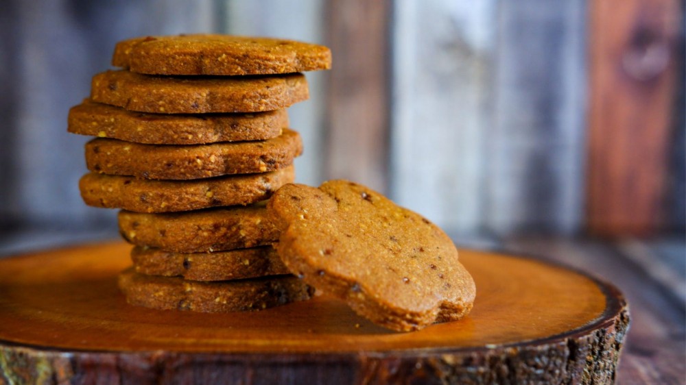 Almond Cardamom cookies on a wooden tray.