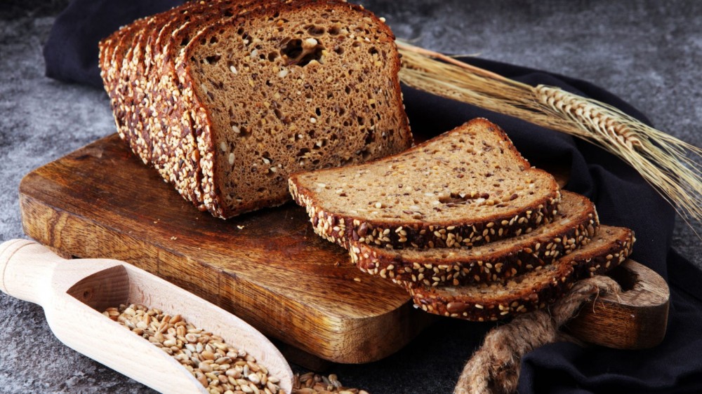 Sliced whole wheat bread on a cutting board.