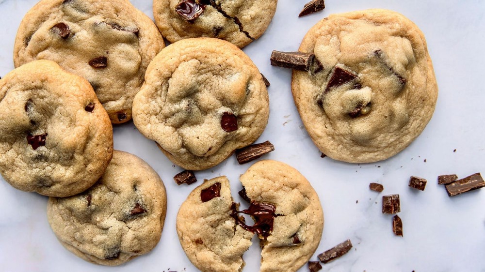 Homemade chocolate chip cookies on a marble countertop.