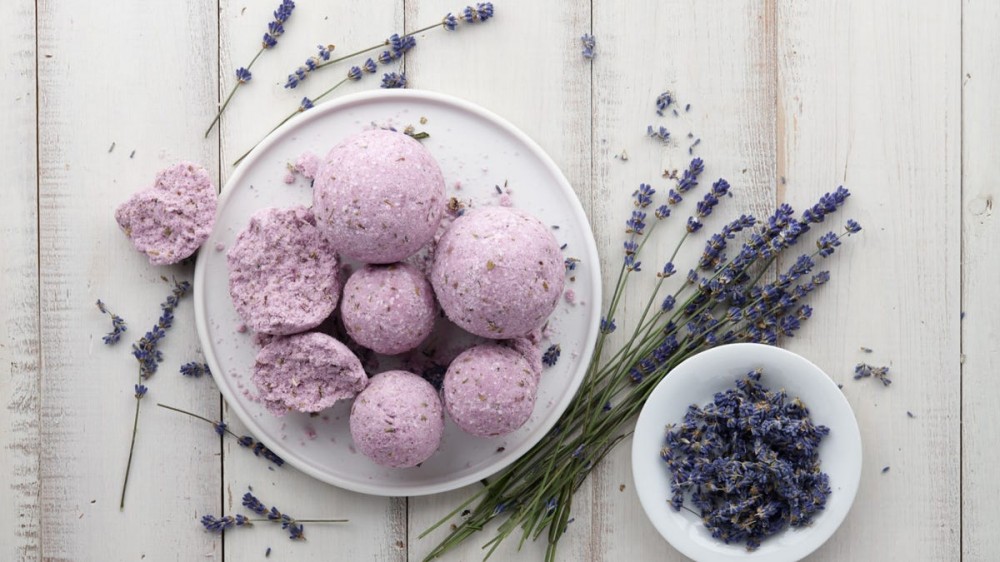 A bowl is filled with lavender bath bombs.