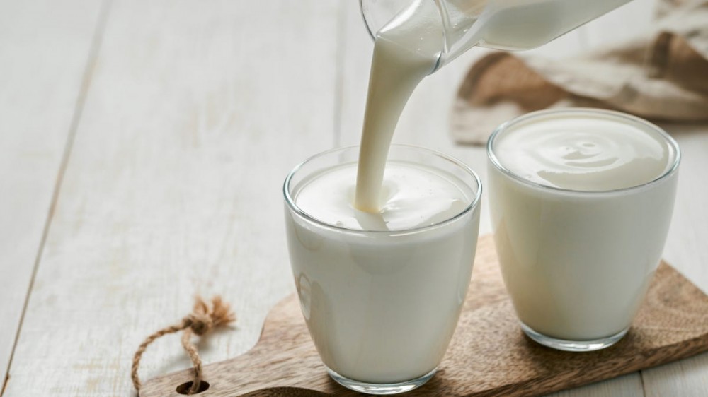 Pouring buttermilk into glasses.