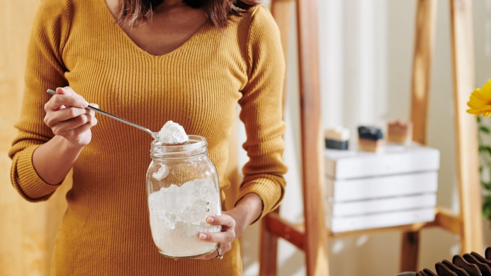 A woman with a jar of baking soda