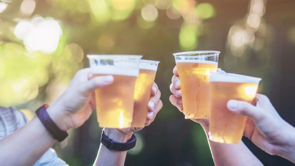 People drink beer outdoors.